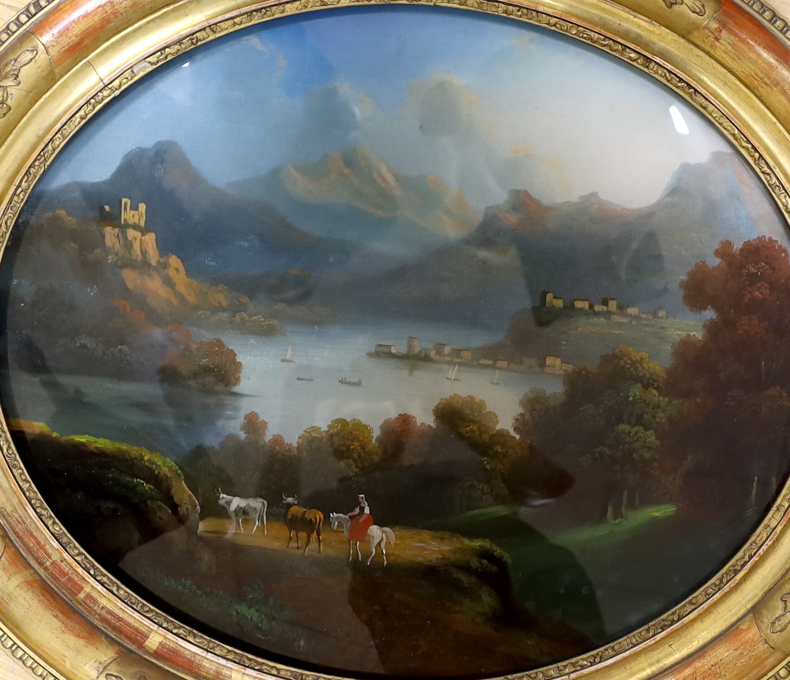 19th century Italian School, reverse glass painting, mountainous lakeside landscape, oval, 44 x 36cm